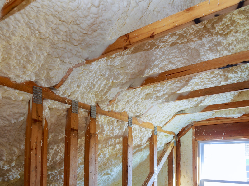 white insulation on a wall and ceiling with wood frames